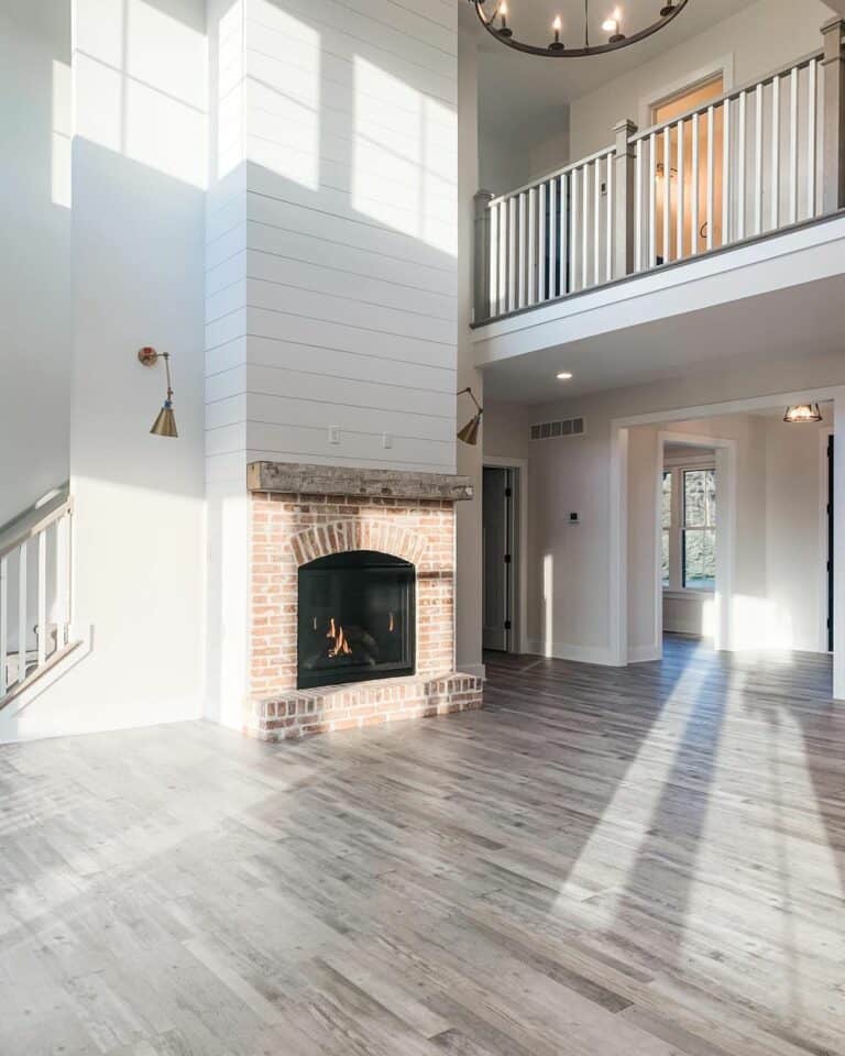 Vaulted Grey Living Room With Brick Fireplace