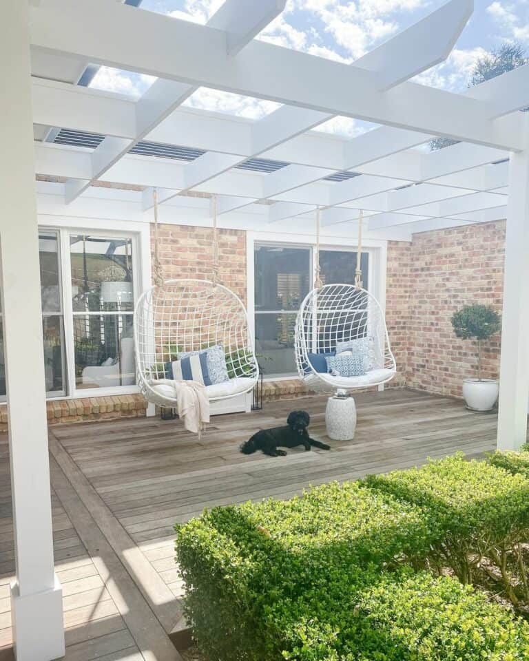 White Pergola With White Hanging Egg Chairs