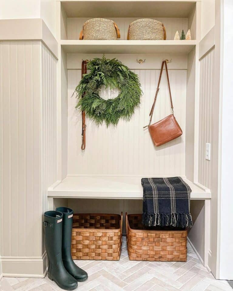 White Tiled Mudroom With Pine Wreath