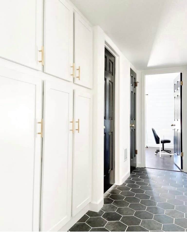 Monochrome Entryway With Gold Door Handles