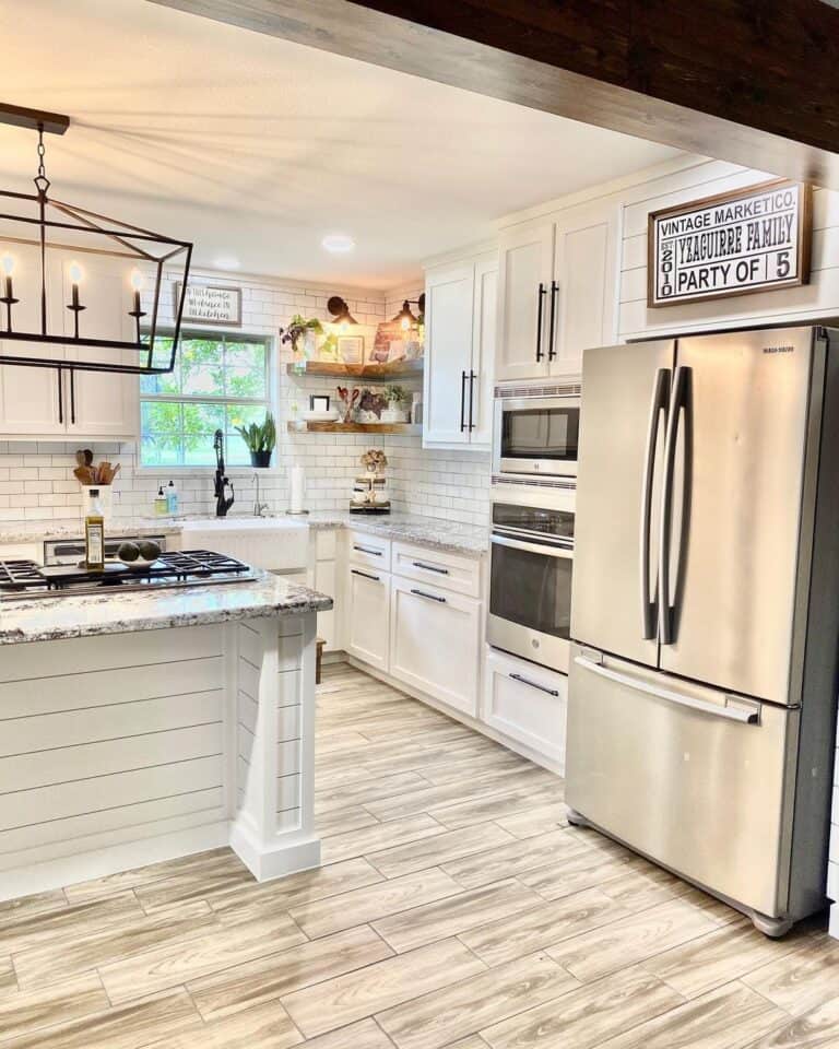 Farmhouse Chandelier Above White Shiplap Island