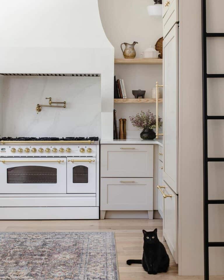 Gold Accents on White Range and Gray Cabinets