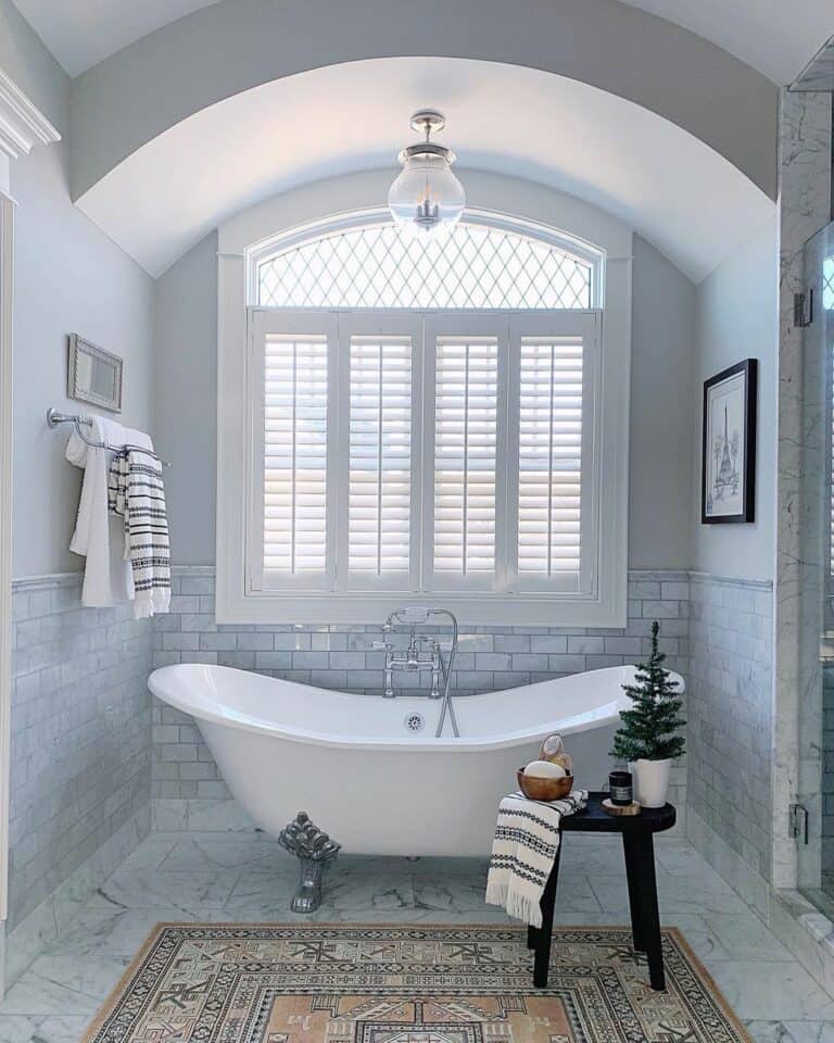 Arched Bathroom Window Behind Clawfoot Bathtub