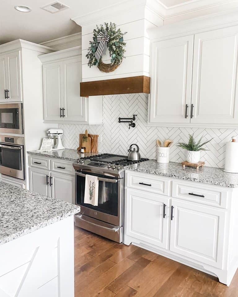 Herringbone Backsplash and White Cabinetry Kitchen