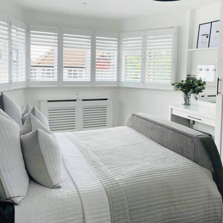 White and Gray Bedroom With Bay Windows