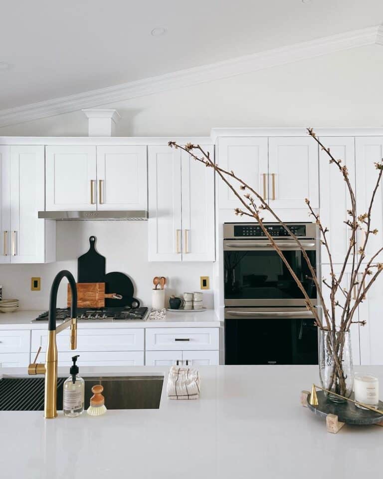 Brass and Black Faucet on Light Grey Counter