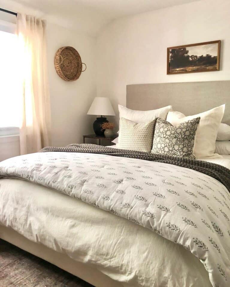 Dark Landscape Painting Over Gray and White Bed