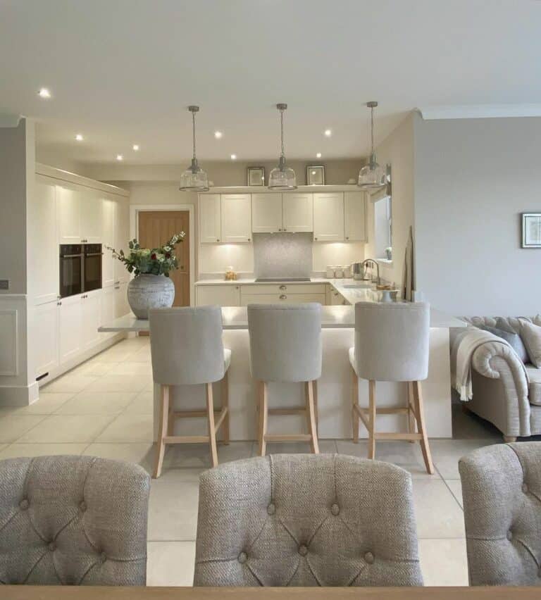 Open-concept Kitchen With Gray Upholstered Chairs