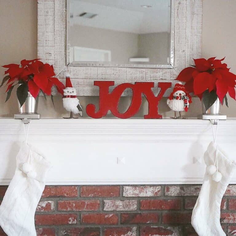 White Farmhouse Mantel With Red Decorations