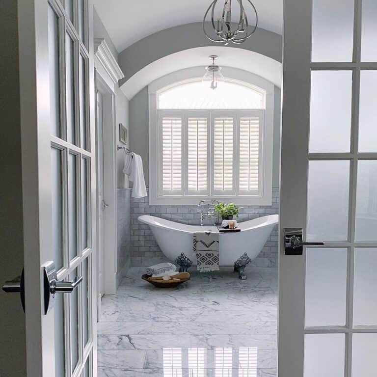 Large Tub with Silver Clawed Feet in Grey Bathroom