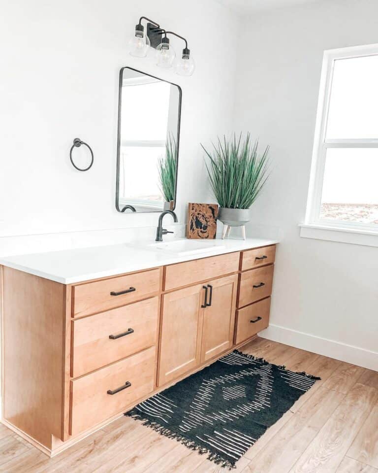 Black Mat Lays Over Wood Bathroom Flooring