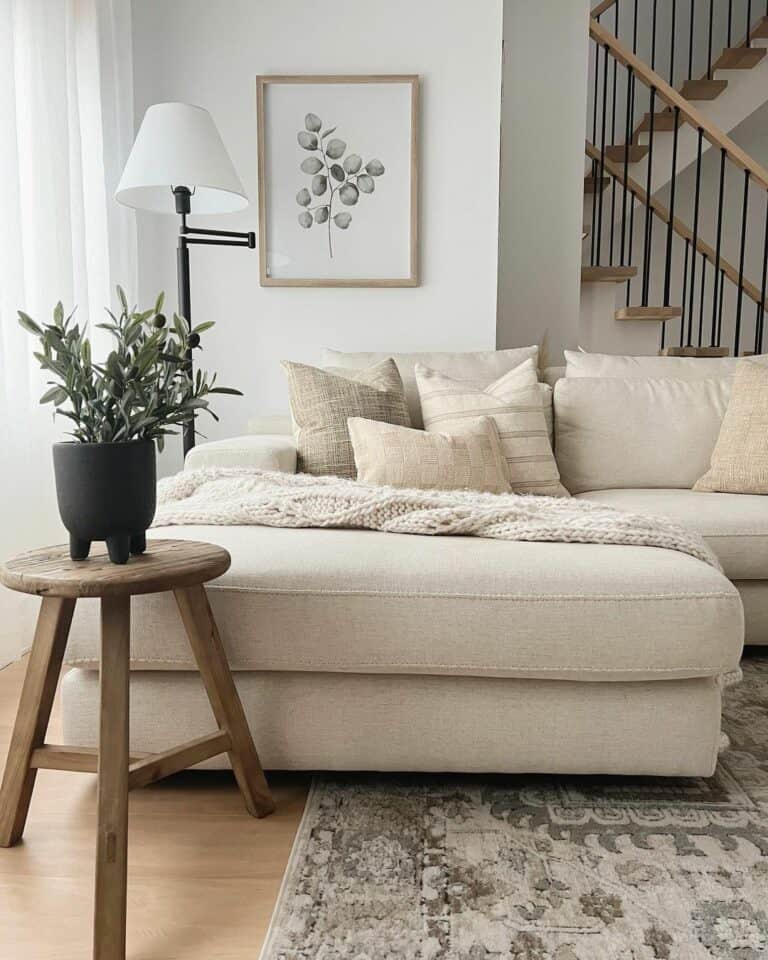 White Sofa in Front of Farmhouse Staircase