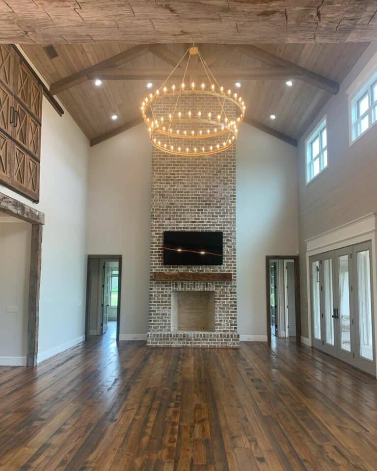 Lodge Ceilings With Recessed Lights and a Gold Chandelier
