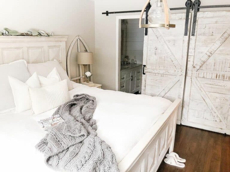 Rustic White Barn Doors Reveal a White Cabinet
