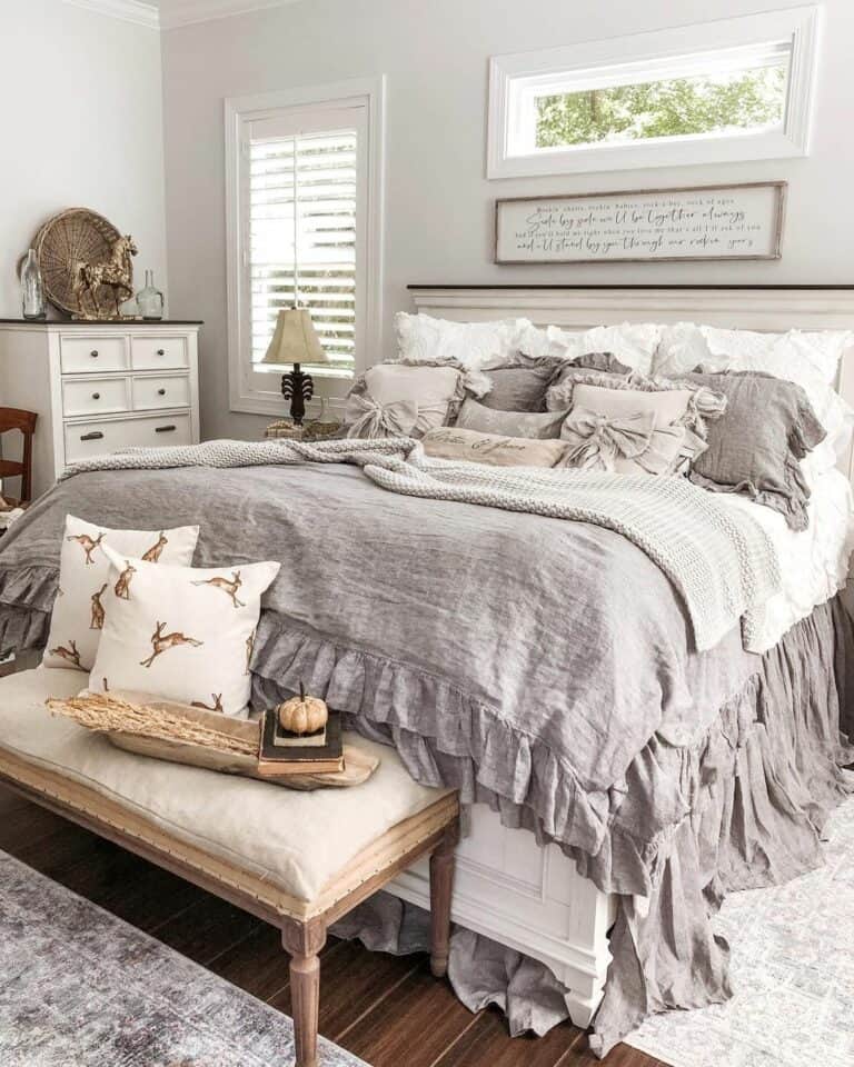 Assorted Grey and White Pillows on Grey Bedding
