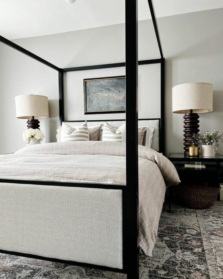 A Grey Painting Above Grey and White Striped Pillows