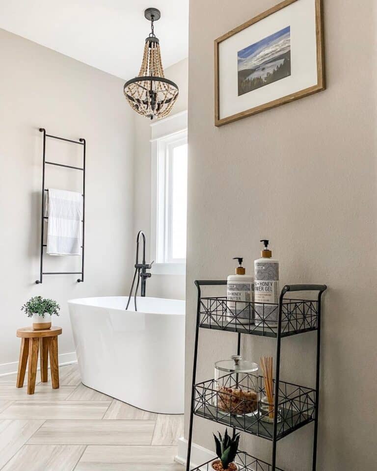 White Oval Freestanding Bathtub and Black Faucet