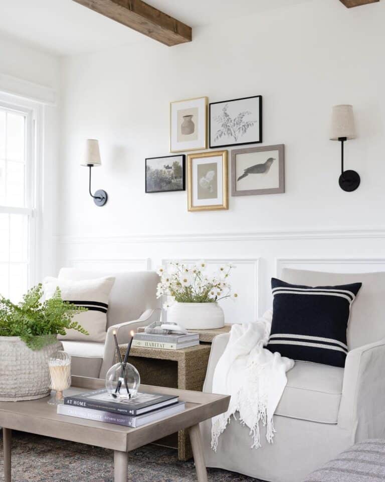 A Gallery of Pictures Between Black Sconces