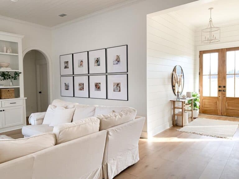 Portraits in Black Frames on a White Living Room Wall