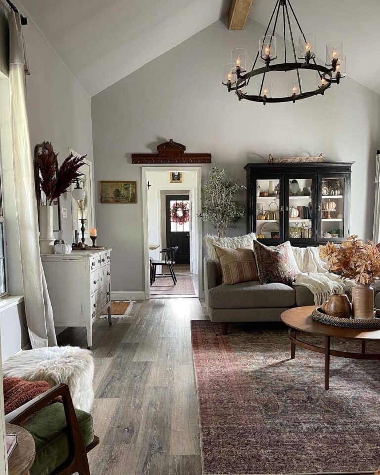 Vaulted Ceiling With Wood Beam and Round Black Chandelier