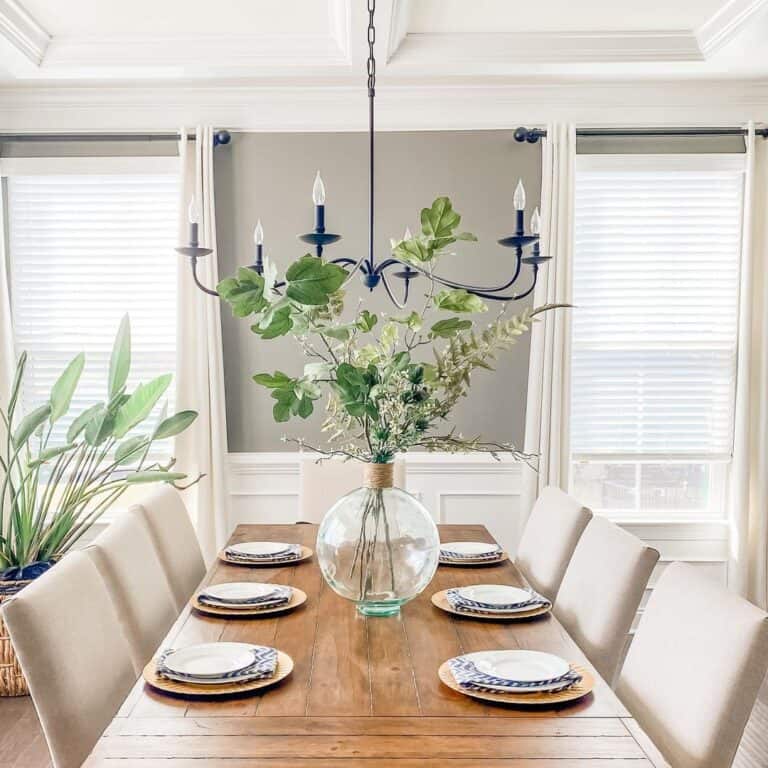 Vase of Greenery on Wood Dining Table