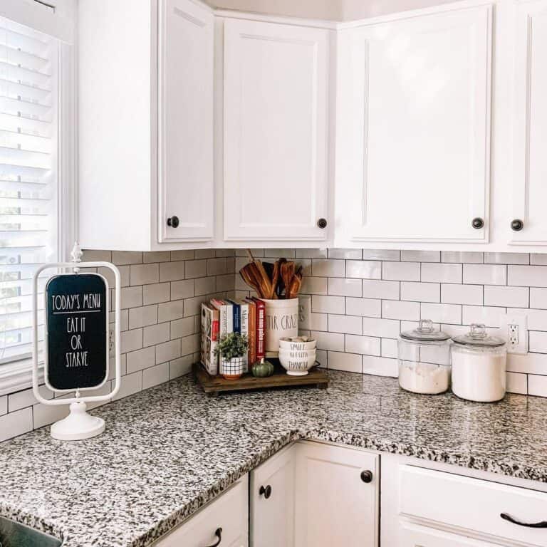 A Farmhouse Kitchen Sign on a Granite Countertop