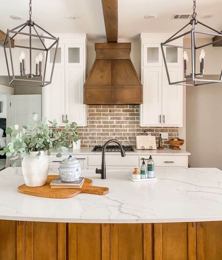 Brick Backsplash Behind Stove and Lantern Pendants