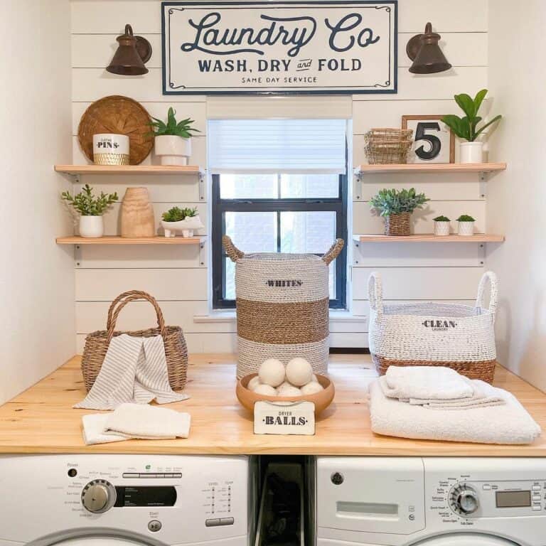 A White Laundry Room Sign Between Black Sconces