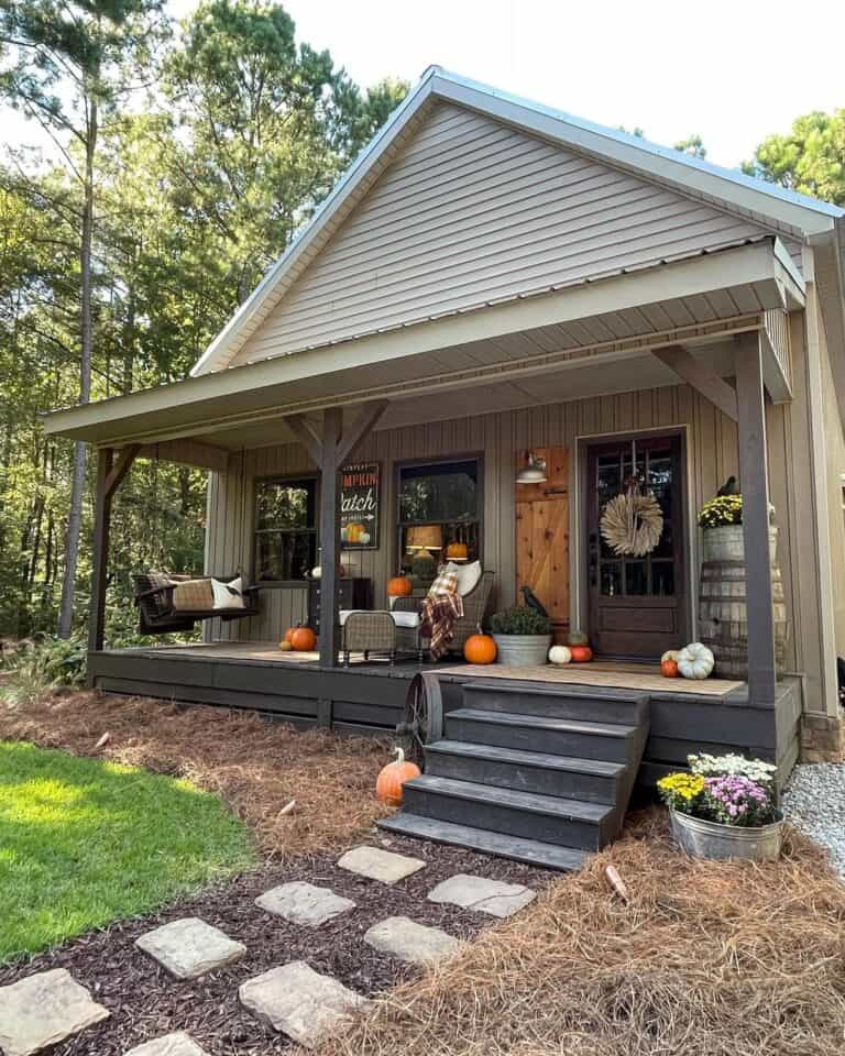 White Farmhouse Outdoor Lighting and Orange Pumpkins
