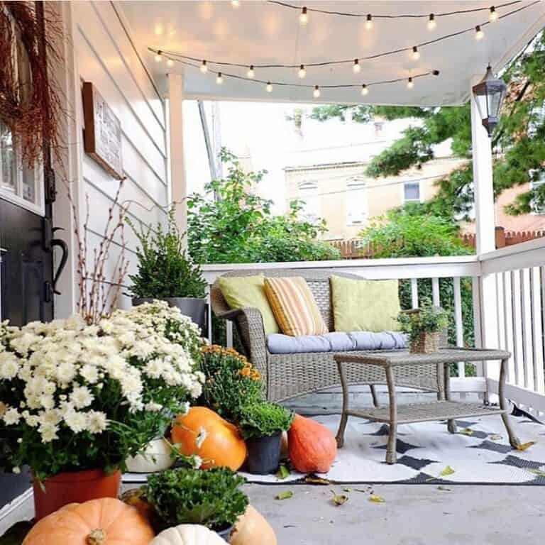 Porch with White Farmhouse Railing and Outdoor Lighting